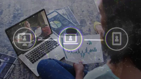 Seated man holding chart, laptop host pointing and activating nodes linking Stock Footage 333965674