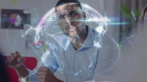 Seated man leaning forward and analyzing tech globe as colleague hand offering Stock Footage 330355378