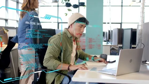Seated man leaning, reviewing tech chart, tapping pad, activating AR HUD, taking Stock Footage 334768421