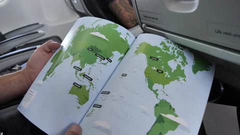 Seated Man In Plane Looks At Map With Pan To Window Stock Footage 170912703