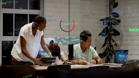 Seated man reacting to good crypto update on laptop colleagues checking tablet Stock Footage 332981345