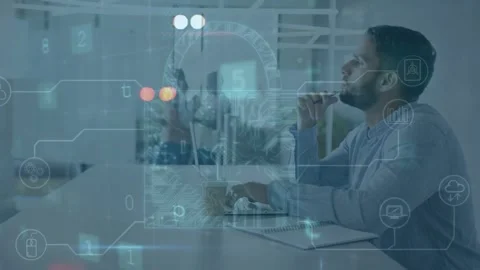 Seated man responding to scanning malware overlays, typing on laptop and noting, Stock Footage 335282737