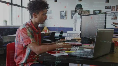 Seated man scanning printout at table, typing on laptop for business while Stock Footage 335282078