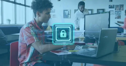 Seated man sorting papers and typing laptop securing files while security lock Stock Footage 329784869