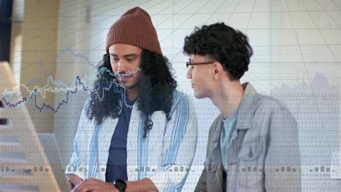Seated man typing, causing blue analytics graph projecting across monitor while Stock Footage 333893770