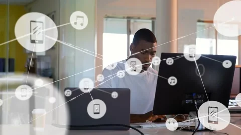 Seated man typing, initiating network overlay of nodes and icons expanding Stock Footage 334036070