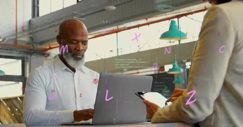 Seated man typing on laptop while woman moving tablet coding, tech overlay Foto stock