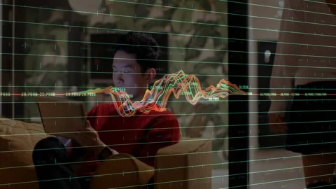 Seated man using device, visualizing data via waveform overlay peaking near face Stock Footage 331085070