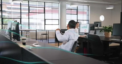 Seated man wearing headset in office hearing alert removing it coworker joining Stock Footage 321781413
