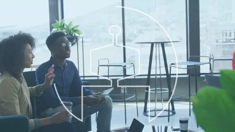 Seated pair holding cup using tablet, animated logo circle overlaying group Stock Footage 334883670