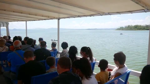 Seated Passengers on the Deck of a Riverboat Sailing on a Lake Stock Footage 244815809