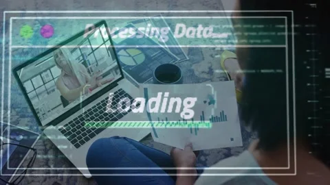 Seated person holding chart, watching laptop as remote host sharing data, HUD Stock Footage 333965675