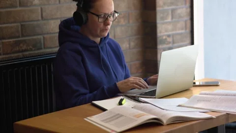 Seated at table student video calls conferencing. Video calls technology Video stock 277772716
