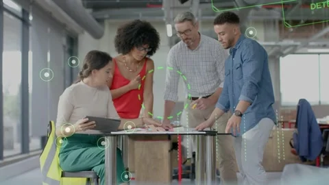 Seated woman tapping pad while team reviewing docs with crypto UI overlaying Stock Footage 333733818