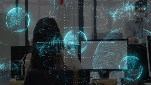 Seated woman using mouse calling colleague reviewing data in tech, globes Stock Footage 333004466