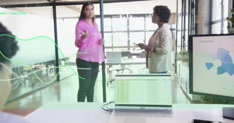 Seated worker turning as women pointing at monitor, business reviewing data via Stock Footage 331002191