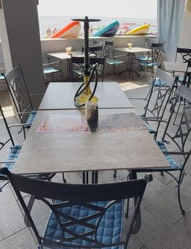 Seating area at a beachside cafe during the day 스톡 사진