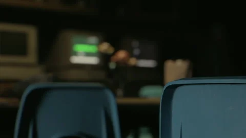 Seating area in a dark room with old computers and a table Stock Footage 342805691