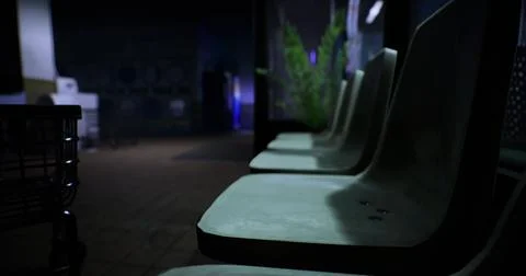 Seating area in a dimly lit indoor space with plants in view Stock Illustration