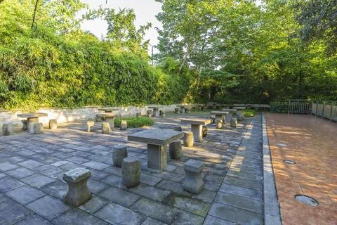 A seating area with stone pillars and bollards in a park in China Stock Photos