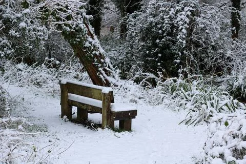 Seating bench covered in snow Stock Photos