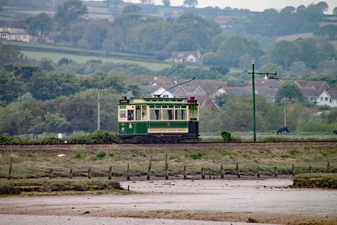 SEATON, DEVON, ENGLAND - MAY 22ND 2012: A green tram travels along the Seaton 스톡 사진