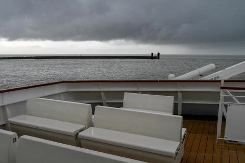 Seats on deck of ferry going from Cuxhaven to Helgoland on a very cloudy and Stock Photos