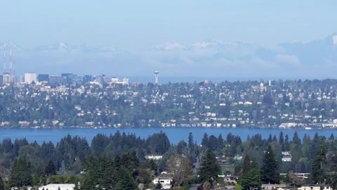 Seattle skyline with distant Space Needle across Lake Washington, snow-capped Stock Footage 335317112