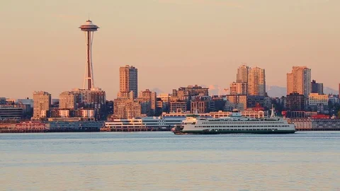 Seattle skyline, Space Needle and Washington State ferry at sunset HD Stock Footage