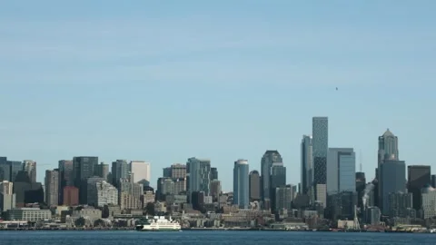 Seattle skyline view across Puget Sound with ferry boat moving through wate.. Stock Footage 334774710