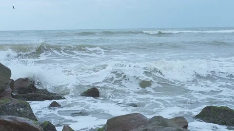Seaview in cloudy day with waves crushing about coastal boulders Stock Footage 160888075