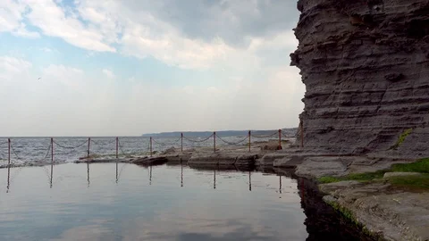 Seawater pool with beating waves in the background Stock Footage 121651883