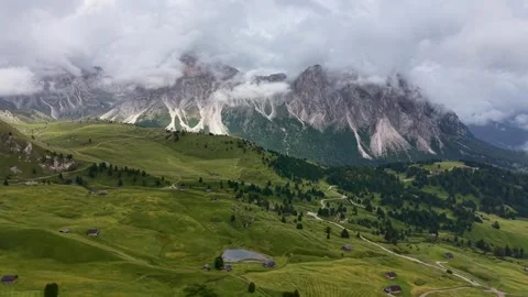 Seceda Meadows with Sassolungo Under Dramatic Clouds Drone View Stock Footage 342235186