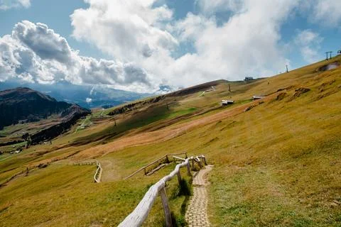 Seceda mountain landscape with hiking path and dramatic clouds in the Dolomit Stock Photos