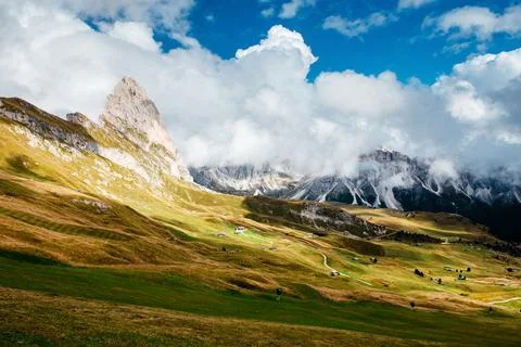 Seceda mountain peak in the Dolomites with rolling green hills and dramatic.. Stock Photos