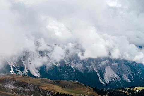 Seceda mountain range in the Dolomites partially obscured by dramatic clouds Stock Photos