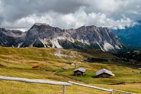 Seceda mountain range with traditional alpine huts in the Dolomites, Italy Stock Photos