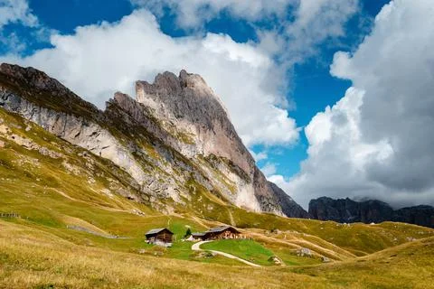 Seceda mountain range with traditional alpine huts and dramatic clouds in t.. Stock Photos
