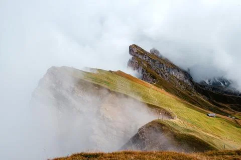 Seceda mountain ridge in the Dolomites with dramatic clouds and green slopes Stock Photos