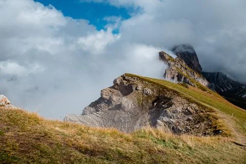 Seceda mountain ridge in the Dolomites with dramatic clouds and green slopes Stock Photos