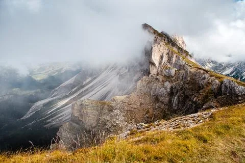 Seceda mountain ridge in the Dolomites with dramatic clouds and green meadows Stock Photos