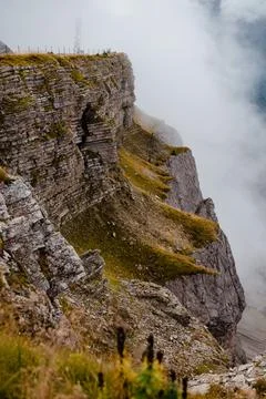 Seceda mountain ridge with dramatic cliffs and misty clouds in the Dolomites Stock Photos