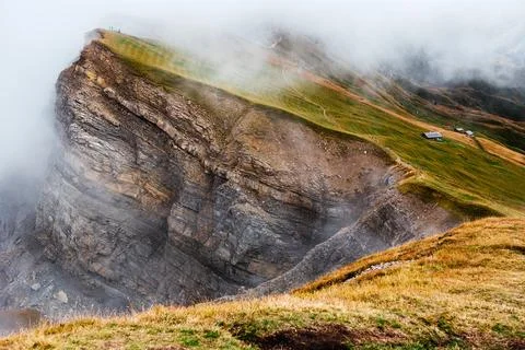 Seceda mountain ridge with dramatic rock formations and misty alpine landscap Stock Photos