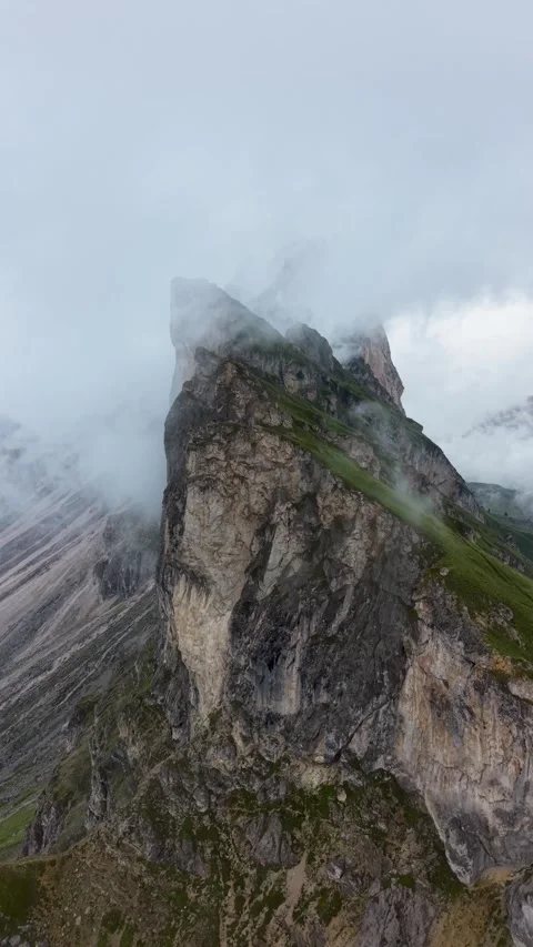 Seceda Ridge Vertical Drone Pullback Through Clouds in the Dolomites Stock Footage 342288770