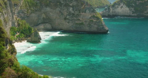 Secluded beach and dramatic limestone cliffs along Diamond Beach in Nusa Penida Stock Footage 344772341