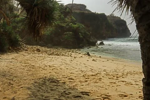 Secluded Beach with Cliffs and Calm Waves Stock Photos