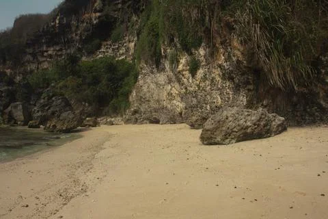 "Secluded Beach with Cliffs and Calm Waves" Stock Photos