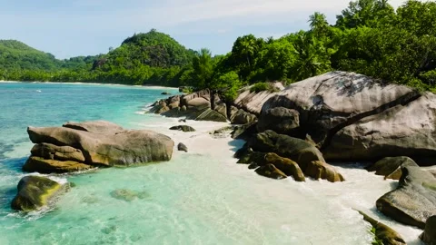 Secluded beach with large granite rocks and clear turquoise sea. Seychelles Stock Footage 302853859