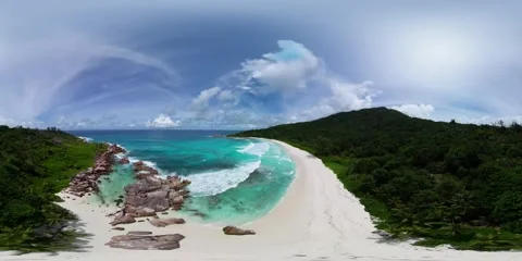 Secluded beach with turquoise waves and rocky shoreline. La Digue, Seychelles. Stock Footage 307817618