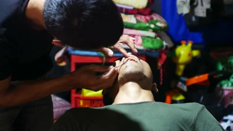 A secluded man fixes his teeth at a rural dentist. Simple tools and place. 4K. Stock-Footage 204634222